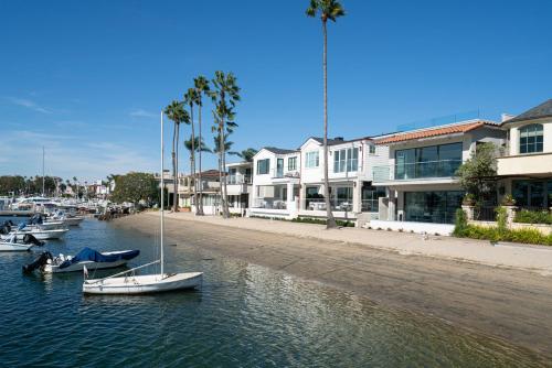 a group of boats in the water next to buildings at 367 Via Lido Soud home in Newport Beach