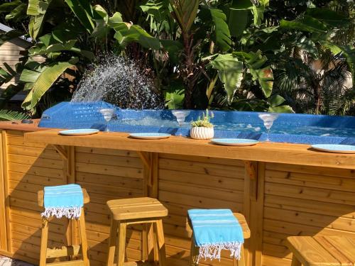 a bar with two chairs and a fountain at 3Gulls Inn Ozona-Boutique Hotel-Steps from Restaurants & Brewery-SwimSpa Pool-Pet Friendly in Palm Harbor
