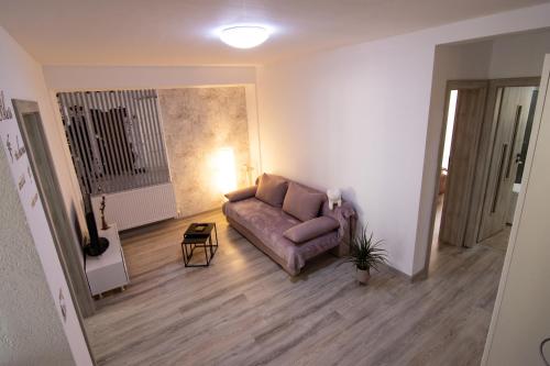 a living room with a couch and a table at Happy Residence Sibiu in Sibiu