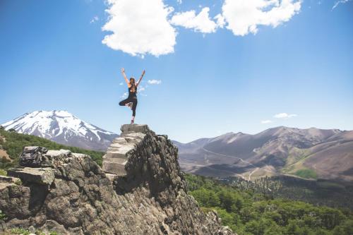 a person standing on the edge of a mountain at Valle Corralco Hotel & Spa in Malalcahuello