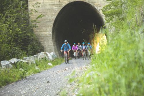 a group of people riding bikes through a tunnel at Valle Corralco Hotel & Spa in Malalcahuello