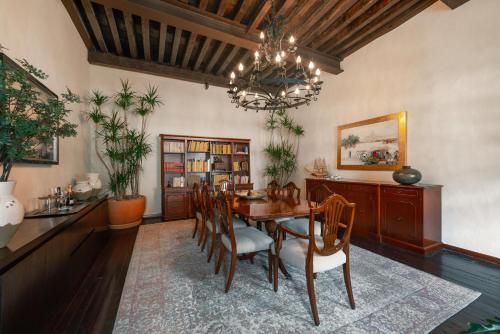a dining room with a table and chairs and a chandelier at Antiguo Molino de San Jerónimo in Mexico City