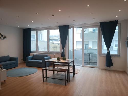 a living room with a table and a couch at L8 Street - Gneisenaustraße 9 in Pforzheim