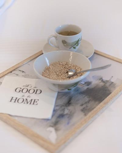 a bowl of food and a cup of coffee on a tray at Kanela Apartment - Hellenic Apartments Avlona in Oinófita