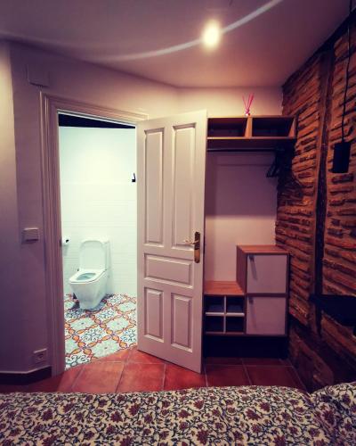 a bedroom with a door leading to a bathroom with a toilet at Holiday Duplex Casco Antiguo in Logroño