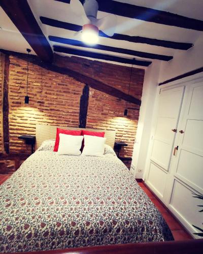 a bedroom with a bed with a ceiling at Holiday Duplex Casco Antiguo in Logroño