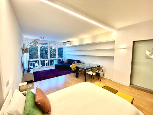 a living room with a couch and a table at Estoril 3 - Beach side Casino Garden Apartment in Estoril