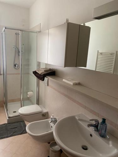 a bathroom with a sink and a toilet and a shower at Dante Zara in Borgata Zarattini