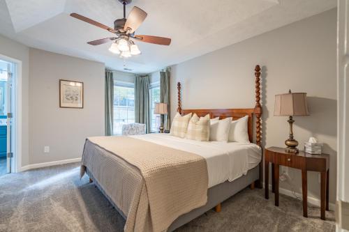 a bedroom with a bed and a ceiling fan at Spacious 3BR Home on Sprawling Serene Grounds in Kingston