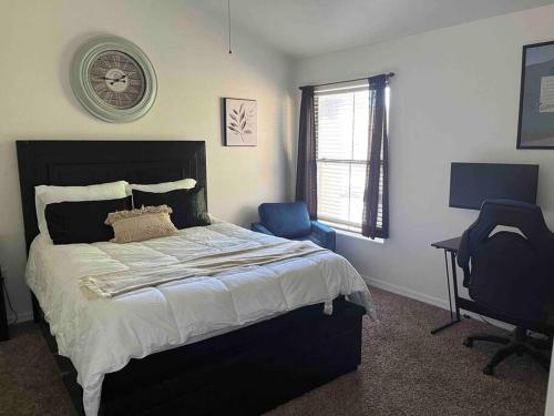 a bedroom with a bed and a desk and a chair at Desert Getaway - Luxury Condo Loft in Chandler