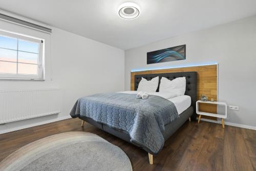 a bedroom with a large bed and a window at ADN Suites - NETFLIX - modern and smart in Günzburg