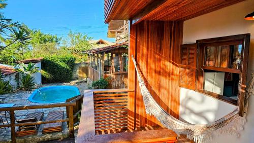 an outside view of a house with a pool at Vila no Rosa Hospedaria in Praia do Rosa