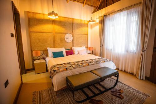 מיטה או מיטות בחדר ב-Tabebuia Spa and Safari Resort