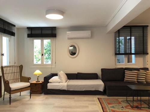 a living room with a couch and a bed at SV Acropolis Residence in Athens