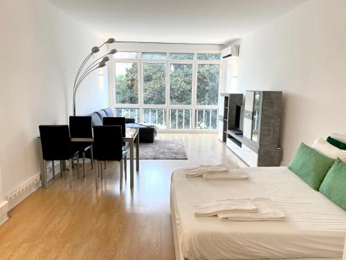 a living room with a bed and a dining room at Estoril 2 & 5- Beach Side Casino Garden Studio in Estoril