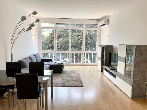 a living room with a couch and a table at Estoril 2 & 5- Beach Side Casino Garden Studio in Estoril