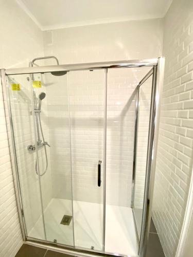 a shower with a glass door in a bathroom at Estoril 2 & 5- Beach Side Casino Garden Studio in Estoril