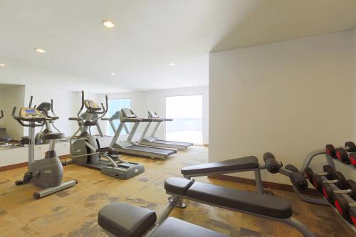 a gym with several treadmills and exercise bikes at Holiday Inn Express Jakarta Pluit Citygate by IHG in Jakarta