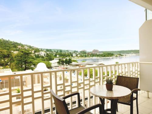 a balcony with a table and chairs and a view of the water at Grand Hotel Portoroz 4* superior – Terme & Wellness LifeClass in Portorož