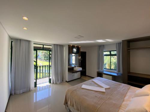 a bedroom with a bed with two towels on it at Spazio Vital Apartments in Florianópolis