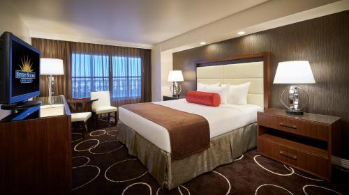 a hotel room with a large bed and a television at Sunset Station Hotel & Casino in Las Vegas