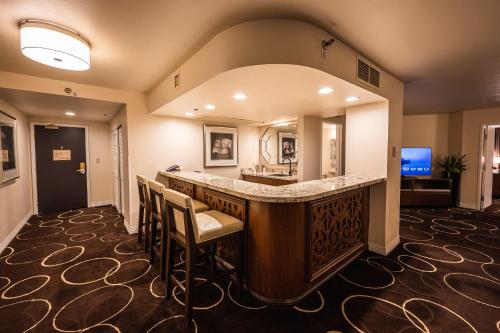 a large room with a bar with chairs and a television at Sunset Station Hotel & Casino in Las Vegas