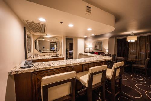 a bathroom with a large vanity with chairs and a mirror at Sunset Station Hotel & Casino in Las Vegas