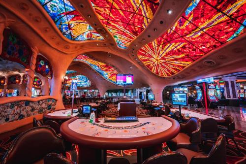 a casino with a large room with a colorful ceiling at Sunset Station Hotel & Casino in Las Vegas