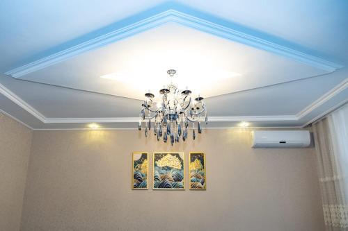 a ceiling with a chandelier in a room at Qafqaz Milan Villa With Outdoor Heated Pool in Gabala
