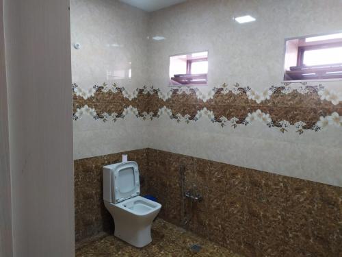 a bathroom with a toilet in a public restroom at Qafqaz Milan Villa With Outdoor Heated Pool in Gabala