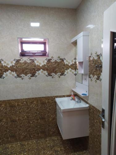a bathroom with a sink and a window at Qafqaz Milan Villa With Outdoor Heated Pool in Gabala