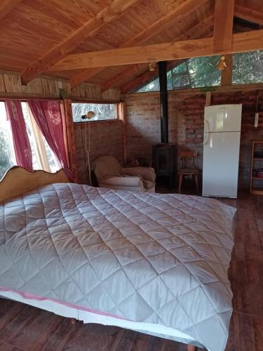 a bedroom with a large bed in a room at BAJO EL ÑIRE in San Carlos de Bariloche