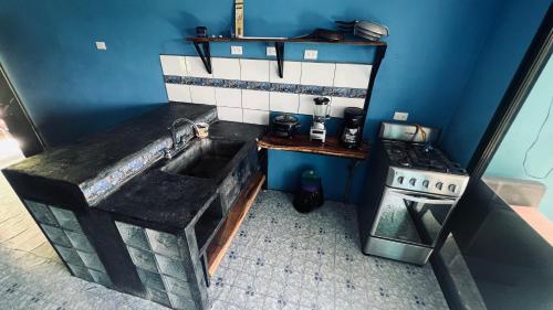 a kitchen with a sink and a stove at Villa Kataleya in Dominical