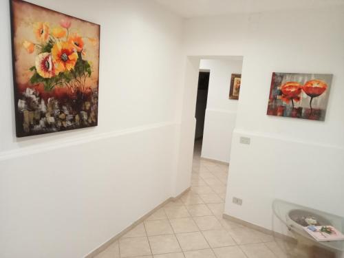 una stanza con due quadri appesi al muro di Appartamento Giglio a Trapani