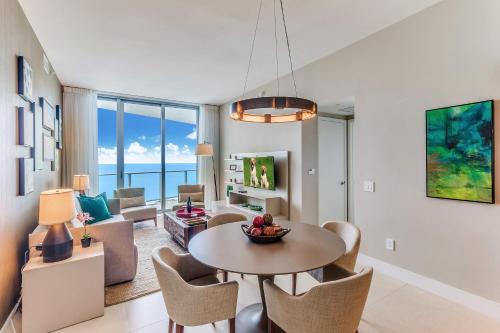 a living room with a table and chairs at Zen 2-Bedroom Ocean View at Lyfe Resort in Hollywood