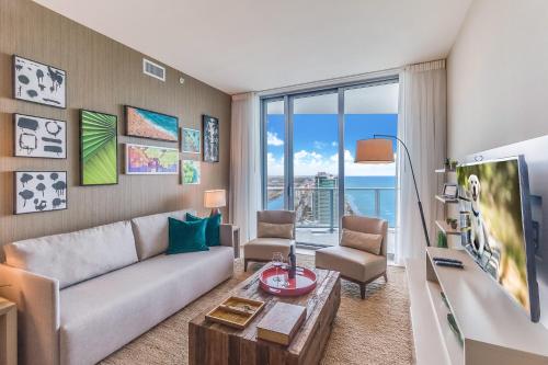 a living room with a couch and a table at Zen 2-Bedroom Ocean View at Lyfe Resort in Hollywood