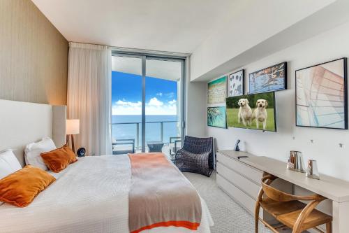 a bedroom with a bed and a desk and a window at Zen 2-Bedroom Ocean View at Lyfe Resort in Hollywood