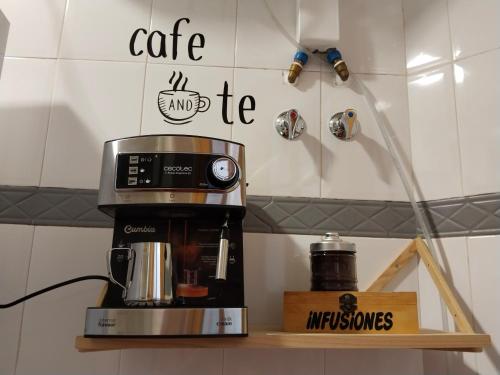 a coffee maker on a shelf in a kitchen at La fuente in Güéjar-Sierra