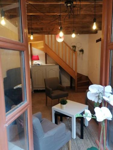 un salon avec un escalier et une table dans l'établissement LE BLANC, AGREABLE MAISON DE CENTRE VILLE, à Le Blanc