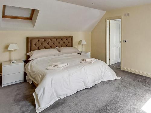 a bedroom with a large bed with two towels on it at Cottage 2 - Uk45645 in Lowick