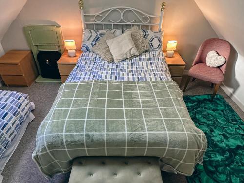 a bedroom with a large bed and two chairs at South Lochs in Marvig