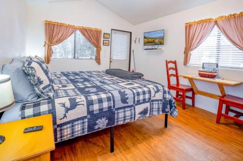 a bedroom with a bed and a desk at The Blue Fox Cabin #8 at Blue Spruce RV Park & Cabins in Tuckerville