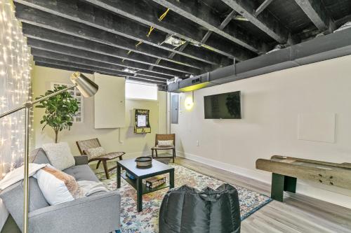a living room with a couch and a tv at Family Fun South Philly Game House Near Sports Stadiums and Concerts in Philadelphia