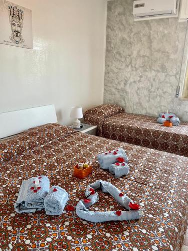 a bedroom with two beds with stuffed animals on them at B&B Marrelli Crotone in Crotone