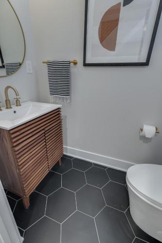 a bathroom with a sink and a toilet at Family Fun South Philly Game House Near Sports Stadiums and Concerts in Philadelphia