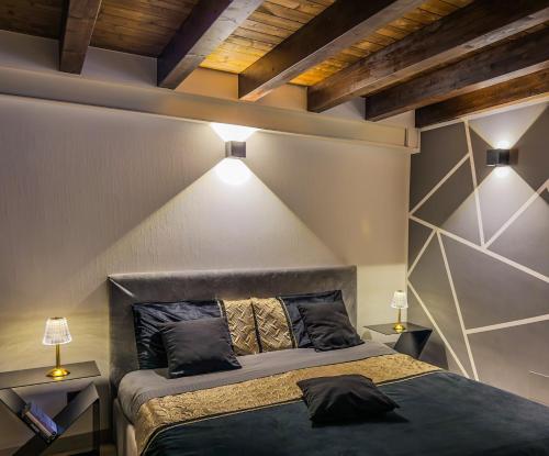 a bedroom with a bed and two night stands at Rouge Suite & SPA PALERMO CENTRO in Palermo