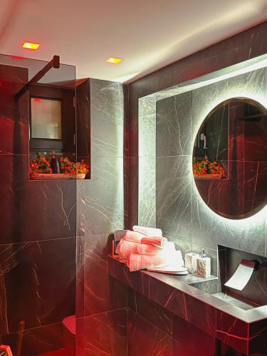a bathroom with a mirror and red tiles at Rouge Suite & SPA PALERMO CENTRO in Palermo