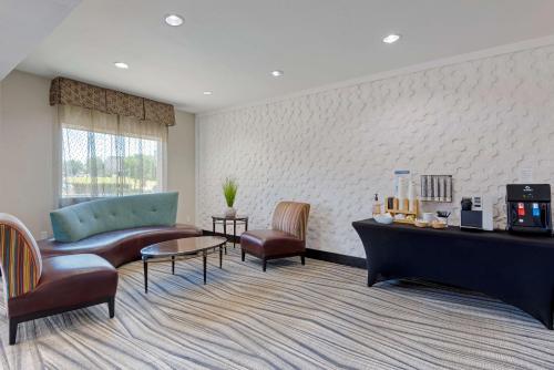 a living room with a couch and chairs and a table at Best Western Plus Arlington North Hotel & Suites in Arlington
