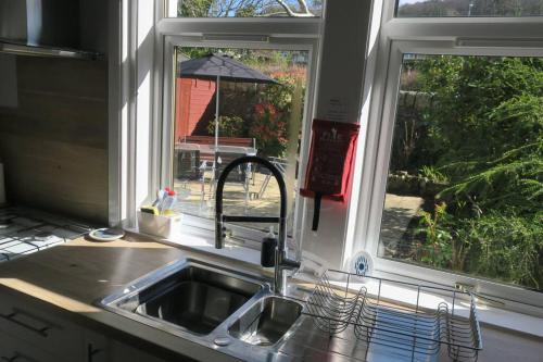a kitchen with a sink and a window at Cumbrae View House (Licence no NA00109F) in Largs