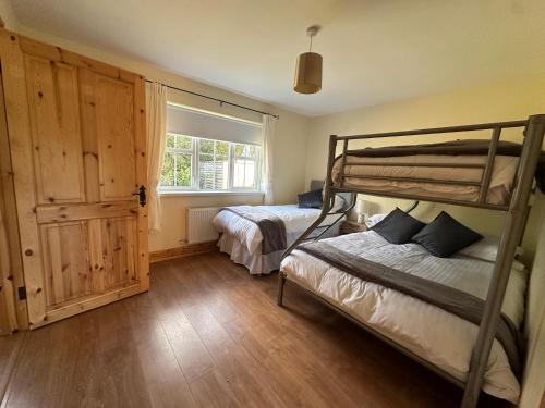 a bedroom with two bunk beds and a window at House in Glenties in Glenties
